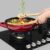 5_4_10.jpg Suporte de Panelas Wok: permite preparar receitas orientais com mais praticidade e segurança no queimador Dual Flame.
